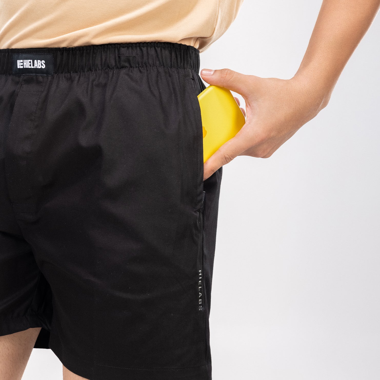 Person wearing a black boxers with an elastic waistband and a visible HIELABS logo.