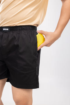 Person wearing a black boxers with an elastic waistband and a visible HIELABS logo.