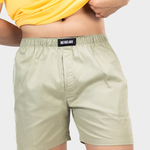 Person wearing a yellow t-shirt and green HIELABS shorts with an elastic waistband.