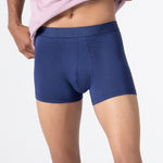 Person wearing a pink t-shirt and classic navy HIELABS Coolism Trunks with comfortable elastic waistband. 
