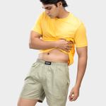 Person wearing a yellow t-shirt and green HIELABS boxers with comfortable elastic waistband.