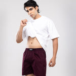 Person wearing a white t-shirt and maroon HIELABS shorts with a comfortable elastic waistband.