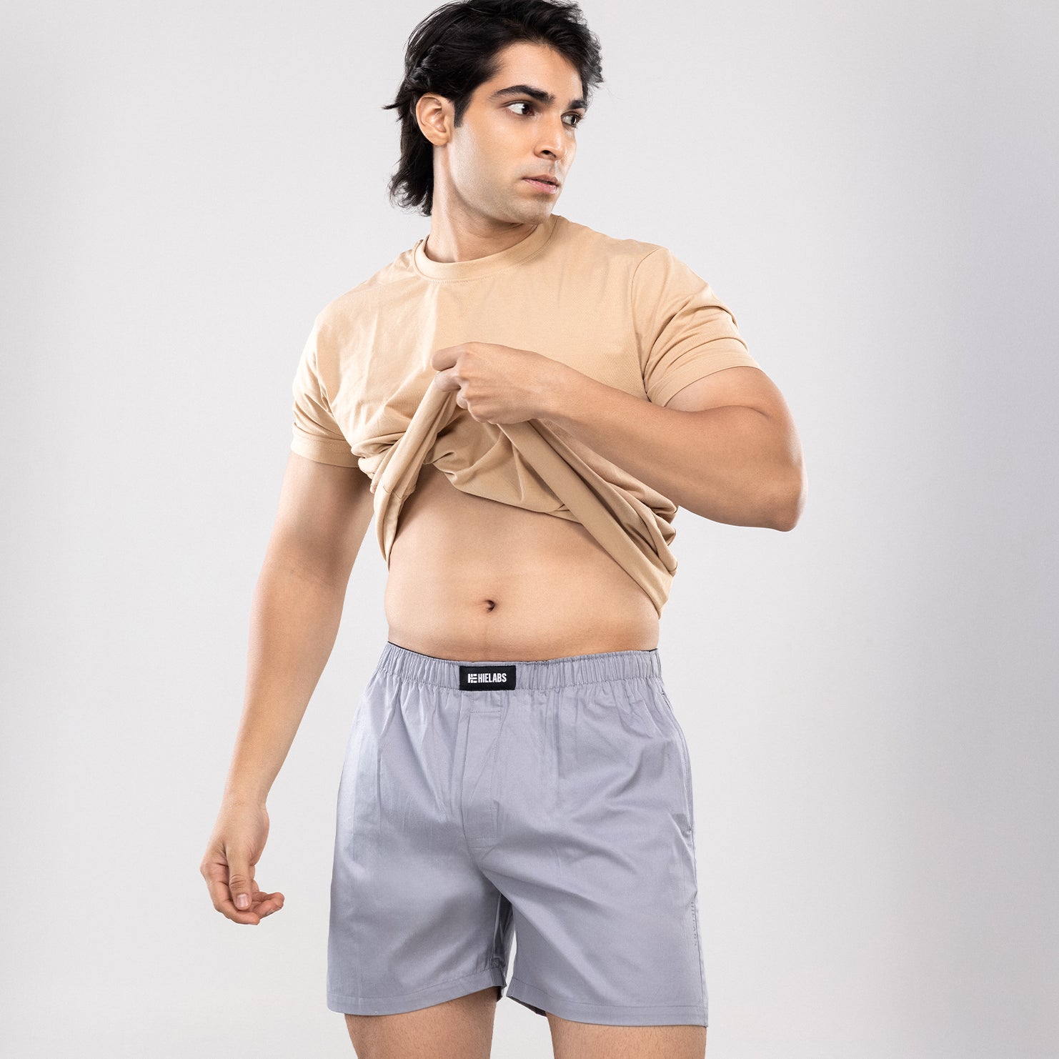 Person wearing a beige t-shirt and grey HIELABS boxers with an elastic waistband.