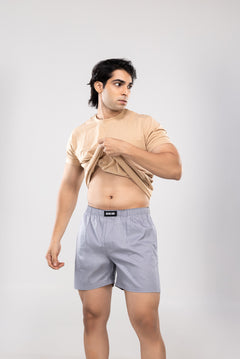 Person wearing a beige t-shirt and grey HIELABS boxers with an elastic waistband.