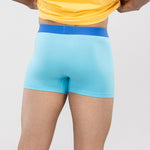 Person wearing a yellow t-shirt and sky blue HIELABS Coolism Trunks with comfortable elastic waistband.  
