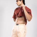 Person wearing a brown t-shirt and peach HIELABS boxers with comfortable elastic waistband.