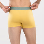 Person wearing a yellow HIELABS Coolism Trunks with contrast waistband, for everyday comfort.