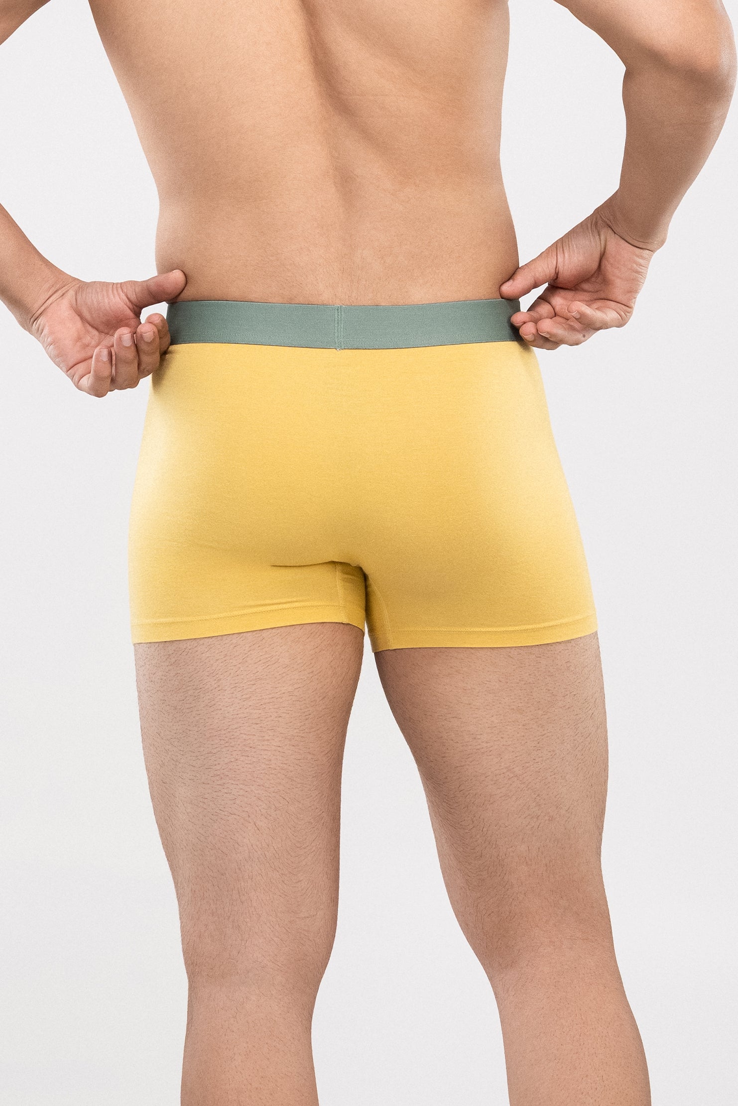 Person wearing a yellow HIELABS Coolism Trunks with contrast waistband, for everyday comfort.